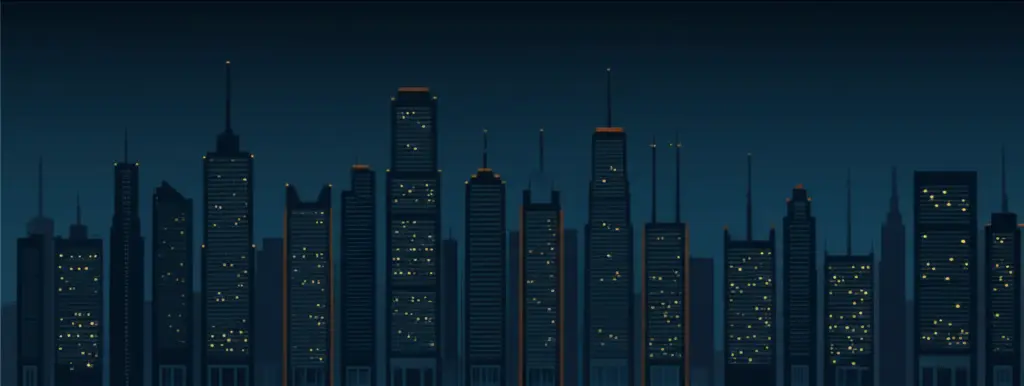 City skyline at night with lit office windows.