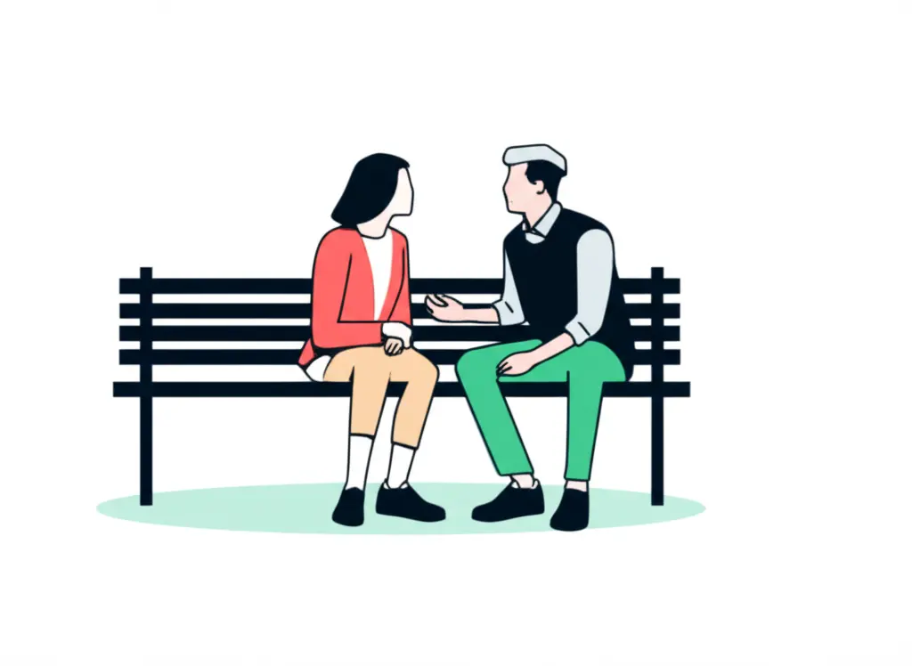 Two people talking on a park bench, one listening intently