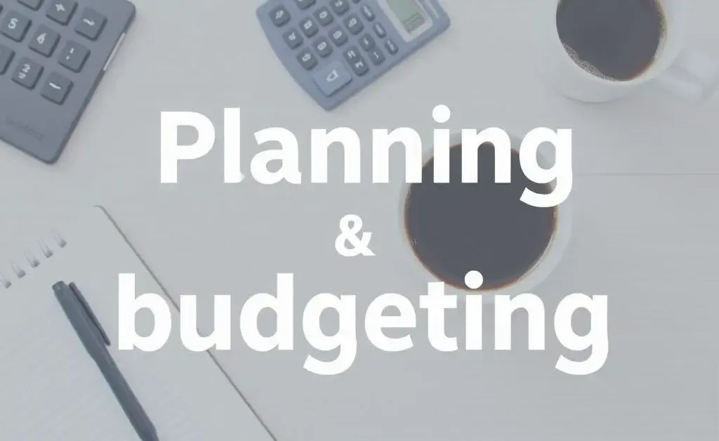 A tidy desk with a notebook, calculator, and a cup of coffee, symbolizing planning and budgeting.