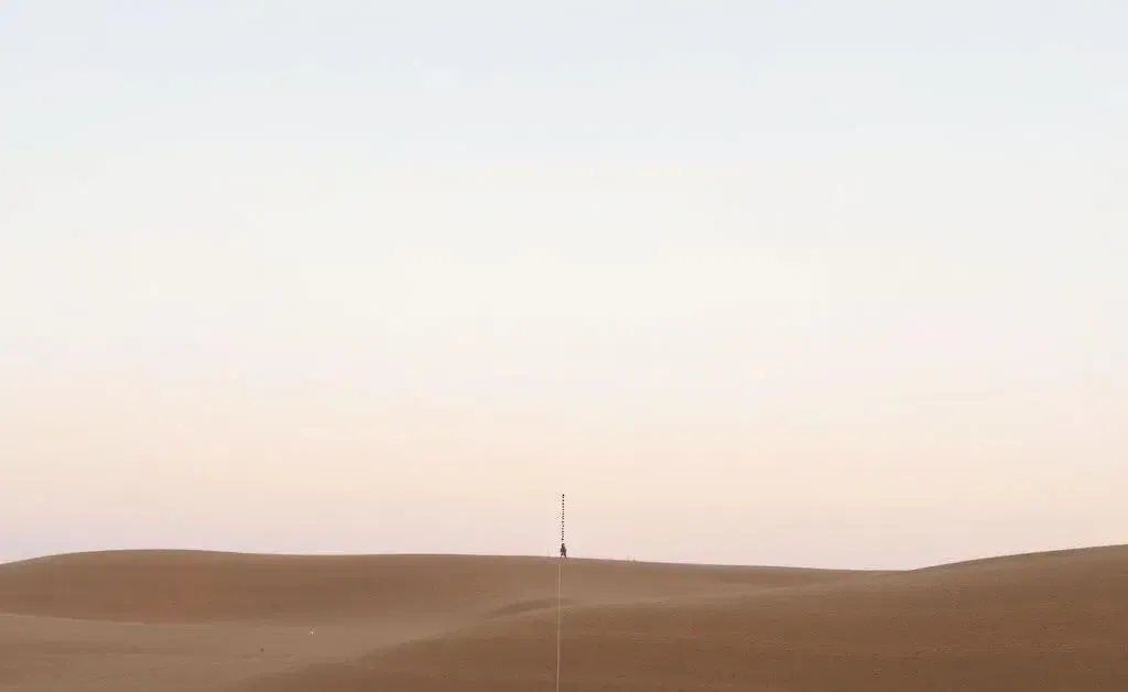 A minimalist landscape showing a faint, dotted line running through two adjacent properties.