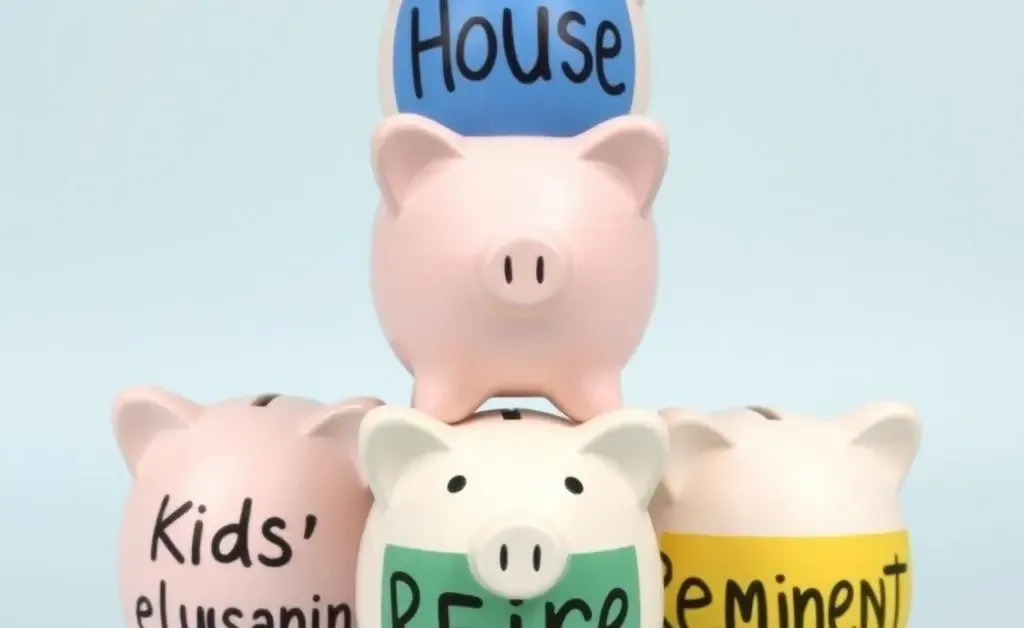 Stack of piggy banks labeled for house, kids' education, and retirement.