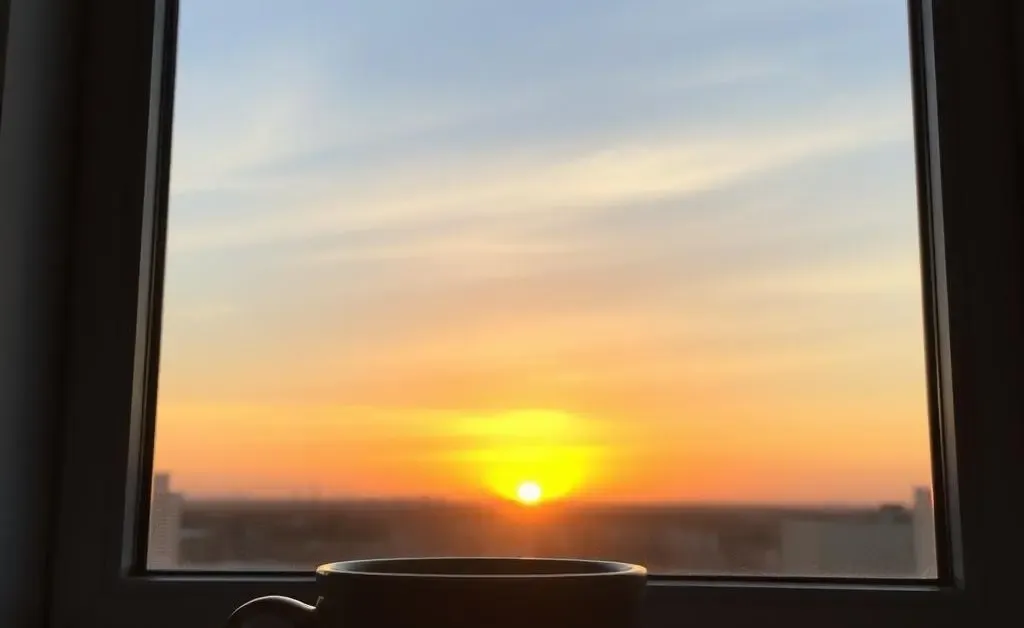 Coffee and a sunrise viewed from the kitchen window.