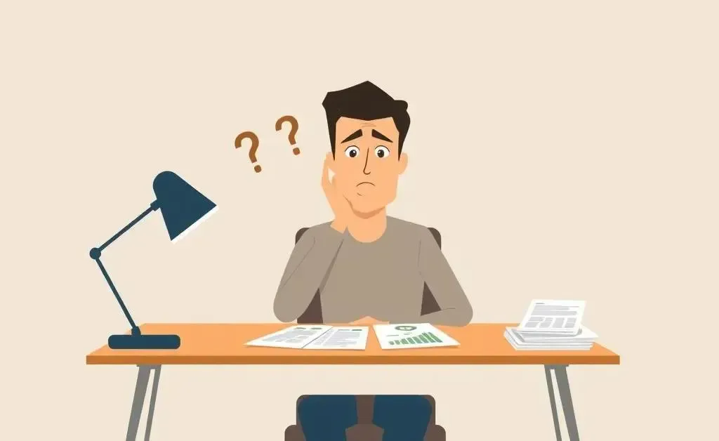 Person puzzled over a credit score drop, sitting at a desk with financial documents