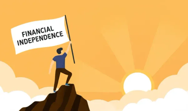 A person on a mountain peak celebrating financial independence