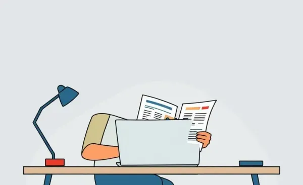 Person planning a budget at a desk with a laptop
