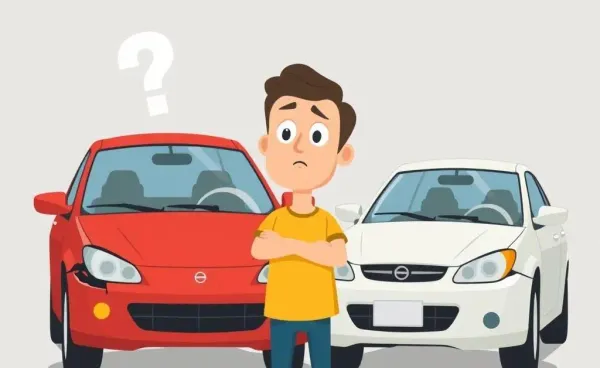 Confused person standing next to two slightly damaged cars