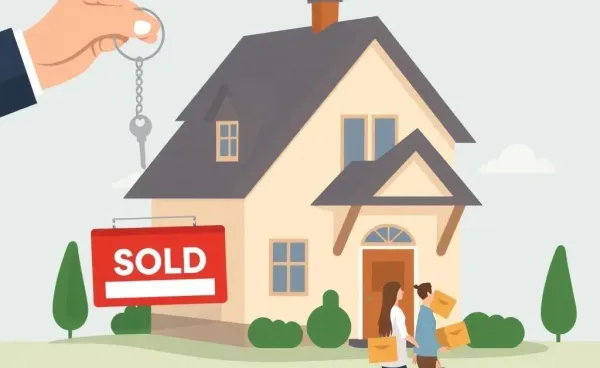 A homeowner holding keys in front of a house with a sold sign